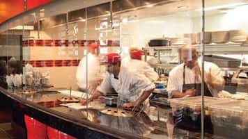 Open restaurant kitchen with chefs working
