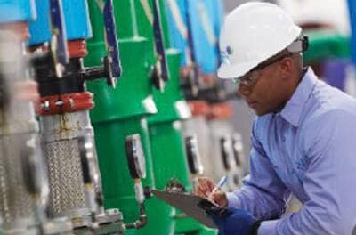 Technician inspecting machinery