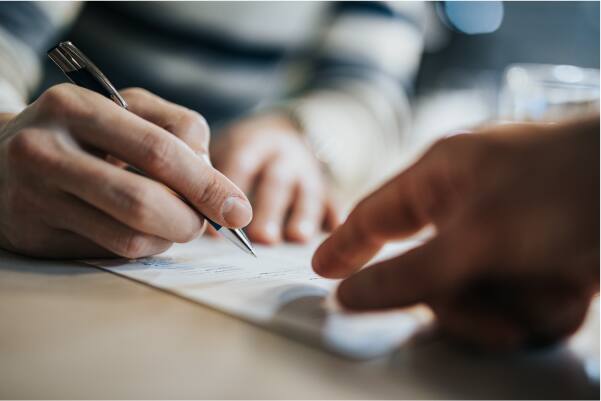 Signing a document.