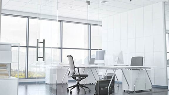 an office cubicle with a white table