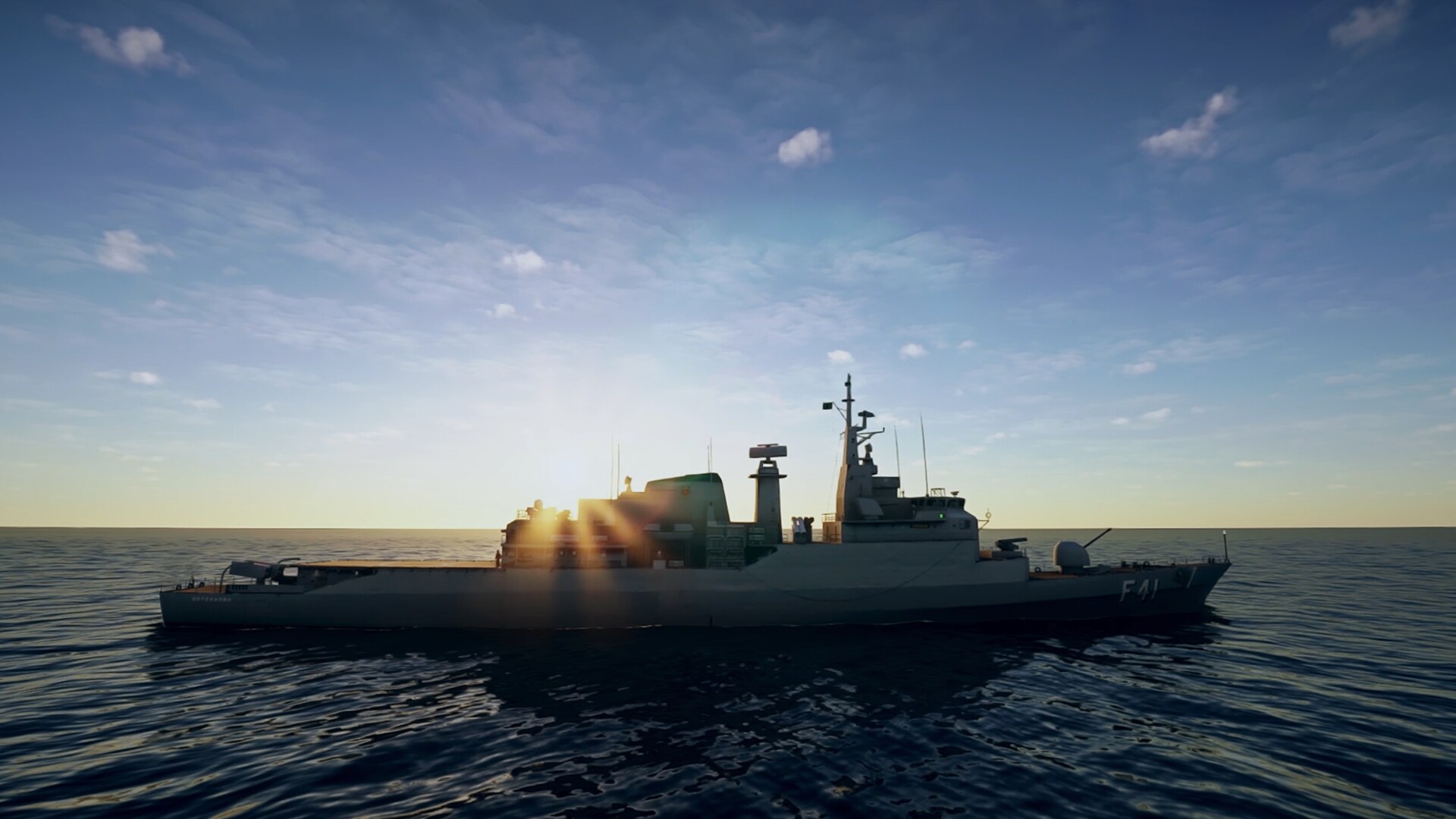 Side view of a large grey naval ship sailing on open sea at sunset, with sunlight reflecting on the water and the ship’s silhouette against the sky.